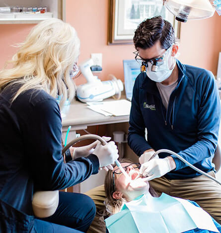 Dr. Westfall and assistant working on a patient's smile